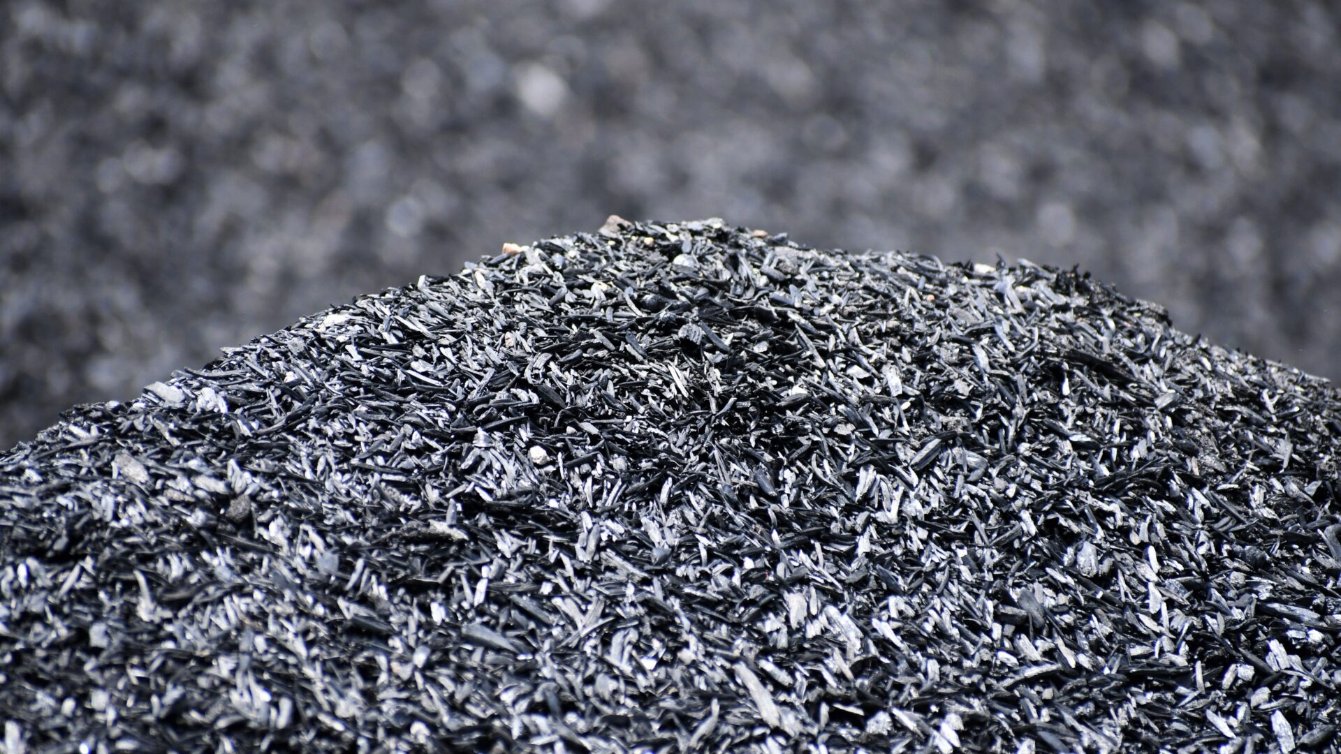 A pile of biochar made from almond shells showing the porous structure that retains water and supports microbial life