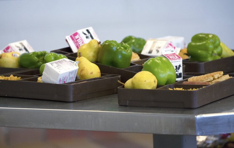 A meal tray of fresh California-grown bell peppers, pears, lemons and milk sits in the dining hall at California State Prison Solano