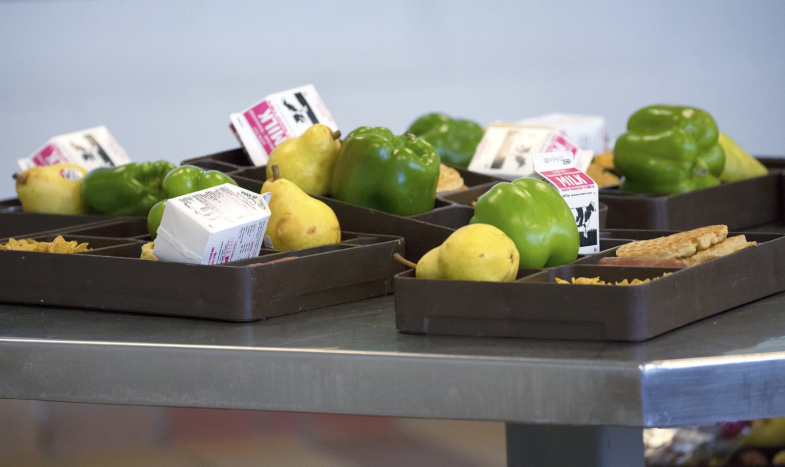 A meal tray of fresh California-grown bell peppers, pears, lemons and milk sits in the dining hall at California State Prison Solano