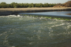 Canal or recharge channel conveying surface water past a concrete weir